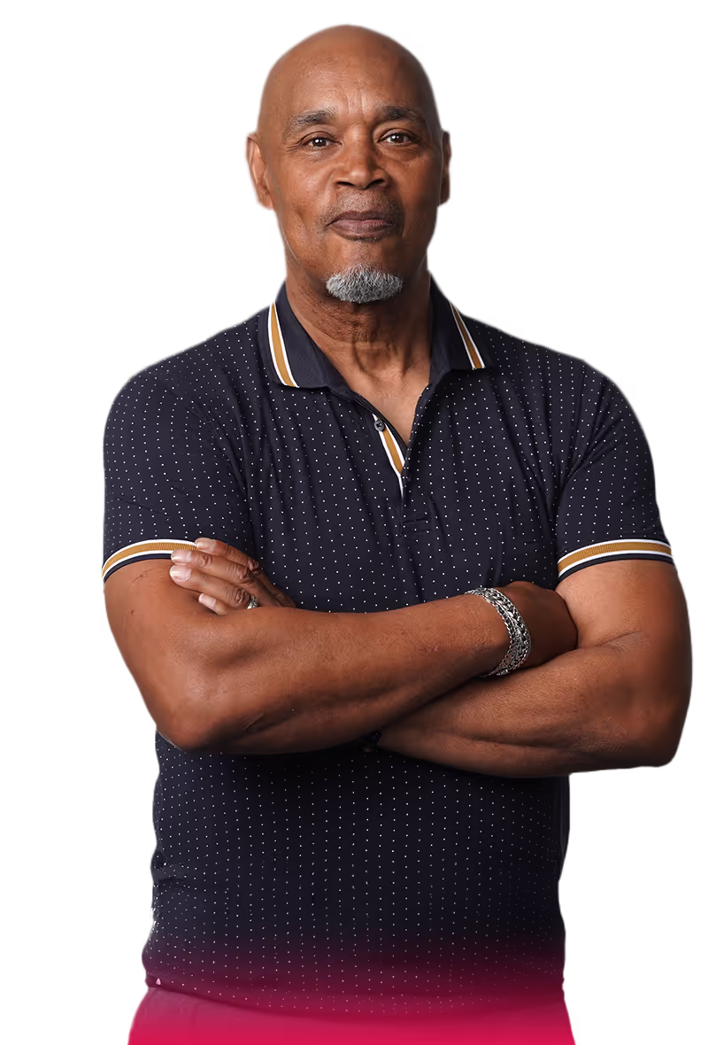 middle aged man wearing a navy blue   
polo with his arms crossed